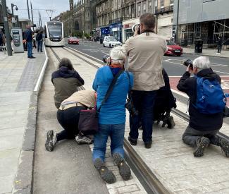 Press photographers filming the tram.