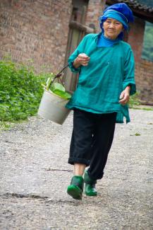 Old lady, colourfully dressed from top to toe.